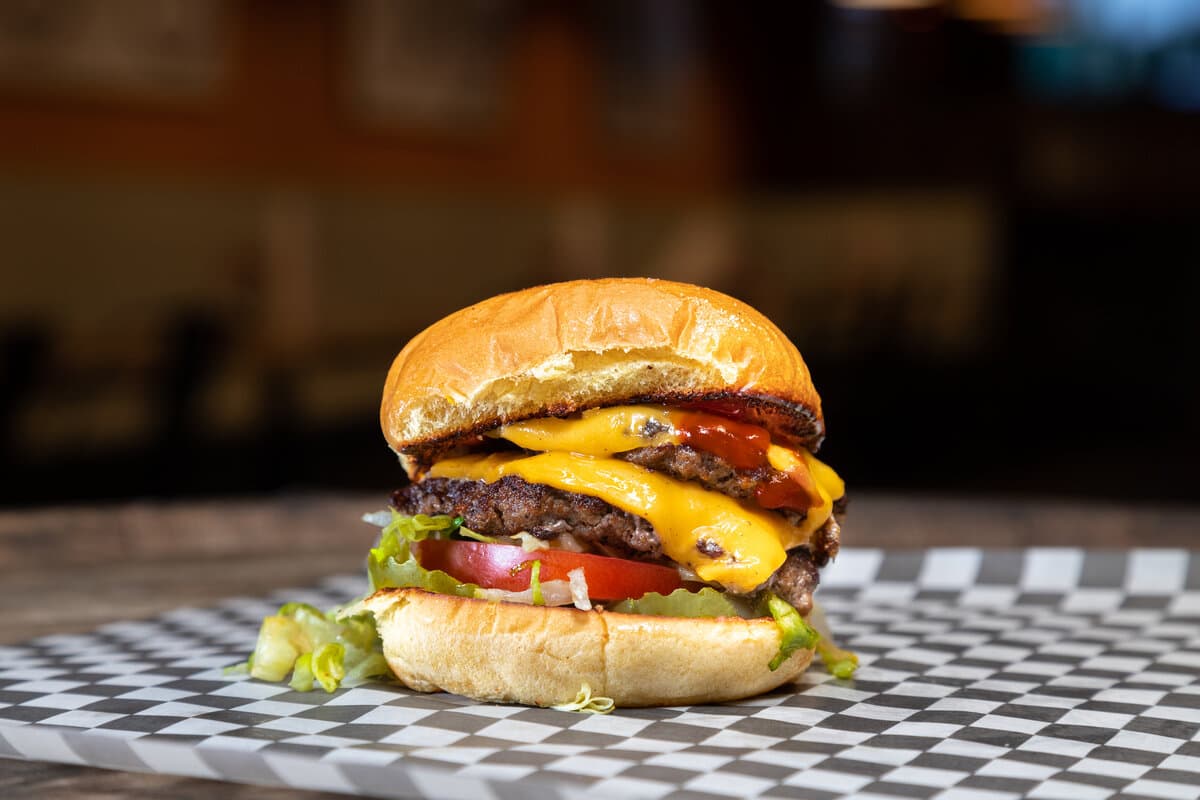 The Blueprint - Two American Wagyu patties, American cheese, lettuce, tomato, pickle, ketchup, and mustard. on a Martin's Potato bun.