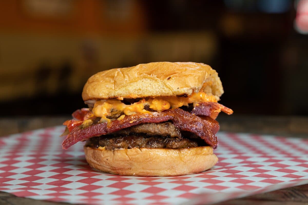 The Buccaneer - Two American Wagyu beef patties, pimento cheese, bacon, and sriracha mayo on a Martin's potato bun