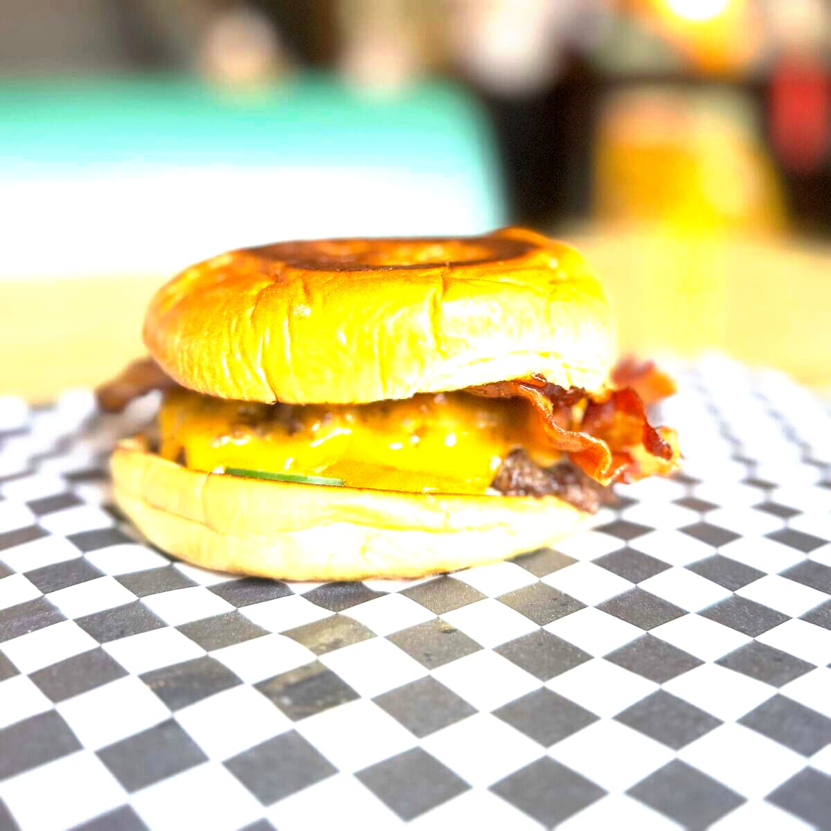 The Patriot - Two American Wagyu beef patties, two slices of cheddar cheese, bacon, habanero bacon jam, fresh jalapeños, and mayo on a Martin's potato bun.