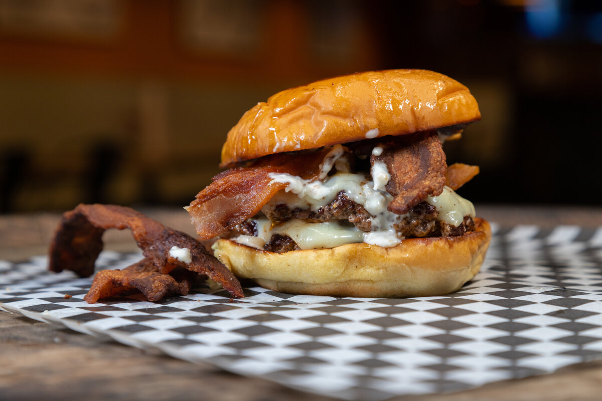The Cowgirl - Two American Wagyu beef patties, bacon, white American cheese, and horseradish aioli on a Martin's potato bun.